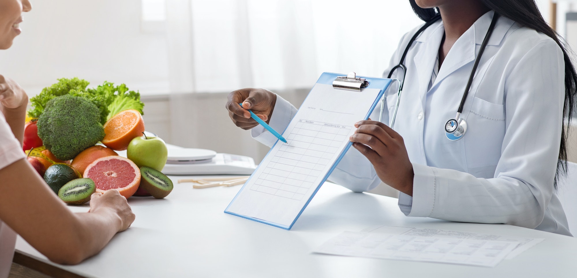 Cropped of nutritionist doctor consultating patient at modern clinic