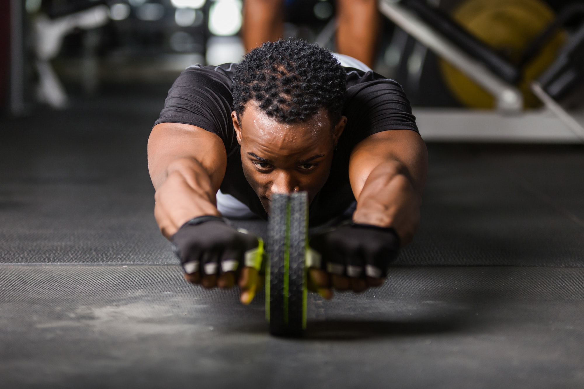 Black African American young man doing workout at the gym