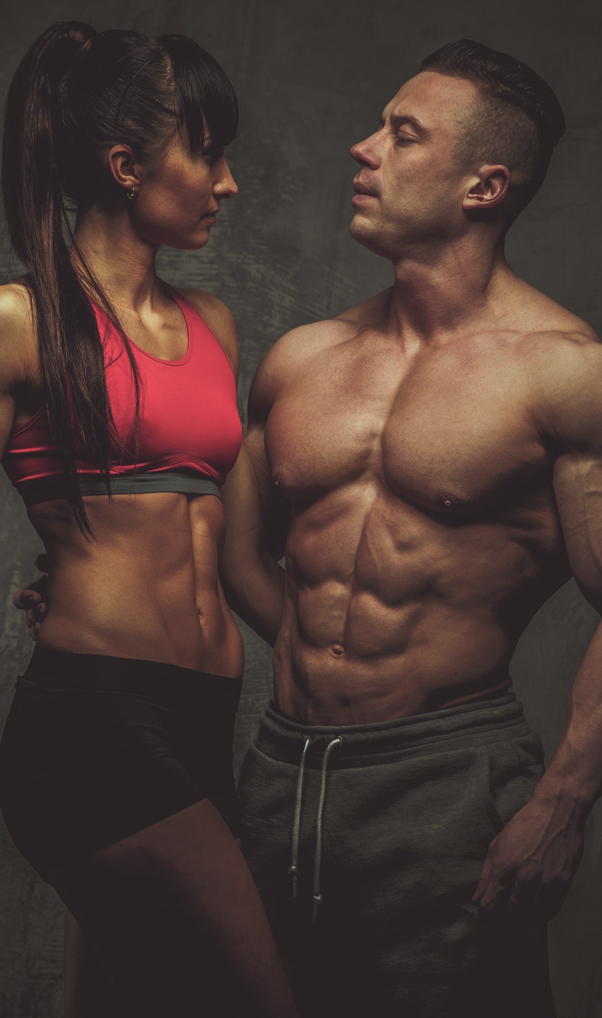 Woman and man bodybuilders posing in studio