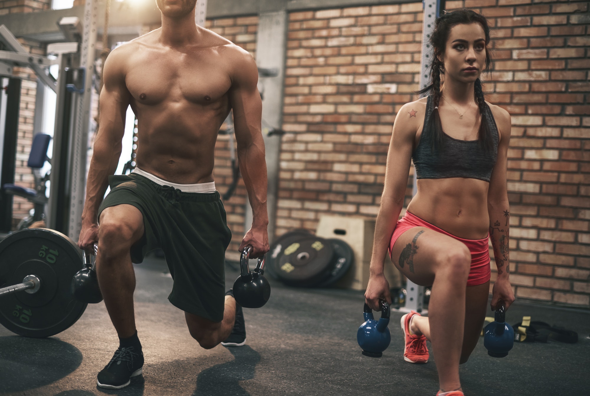 Young couple working out with kettlebells