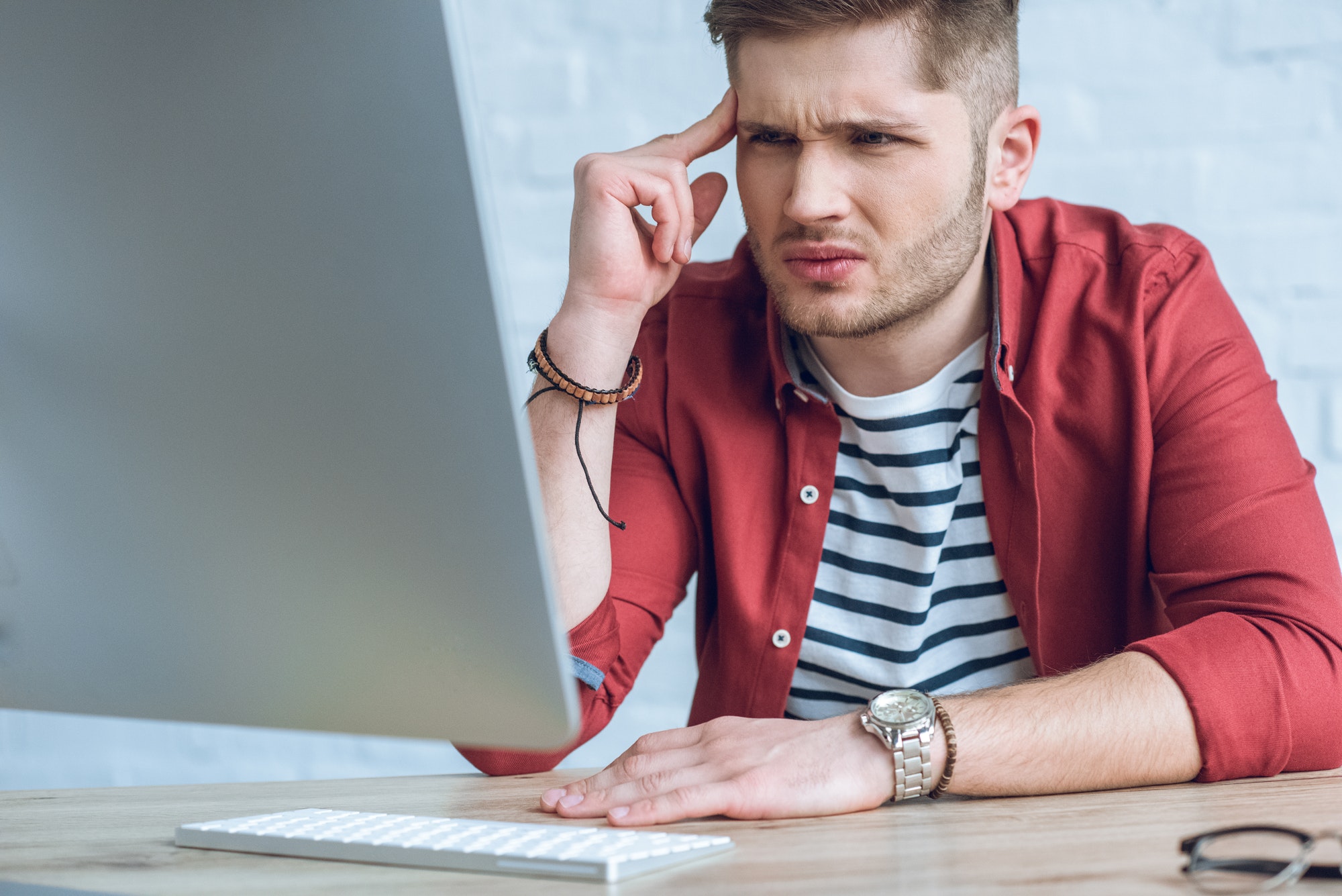 Confused man looking at healthy eating info computer screen