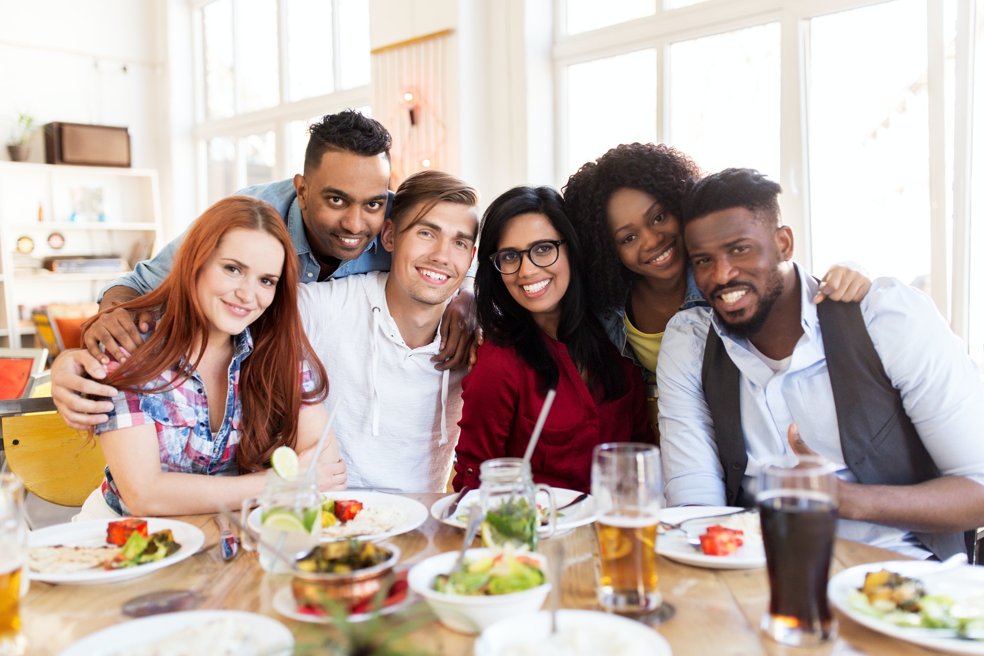 happy friends eating a healthy meal on their diet