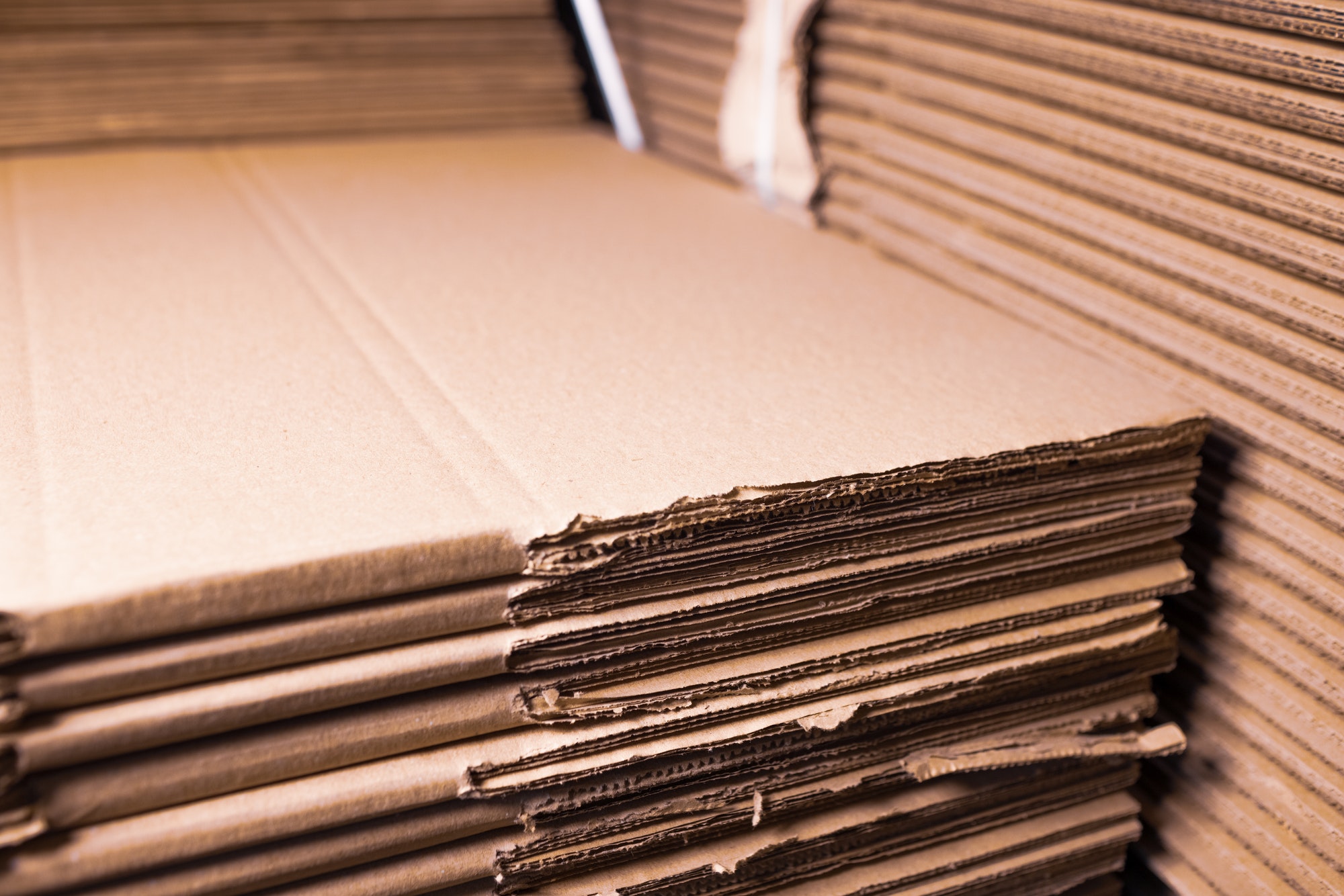 Close-up sides of stacks of cardboard folded