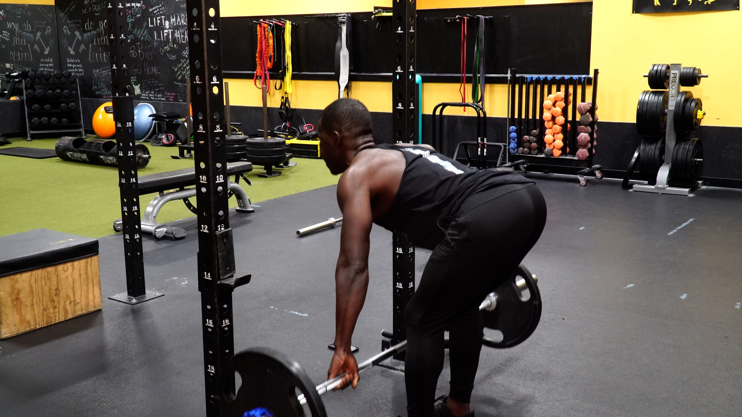 man completing barbell row for back workout