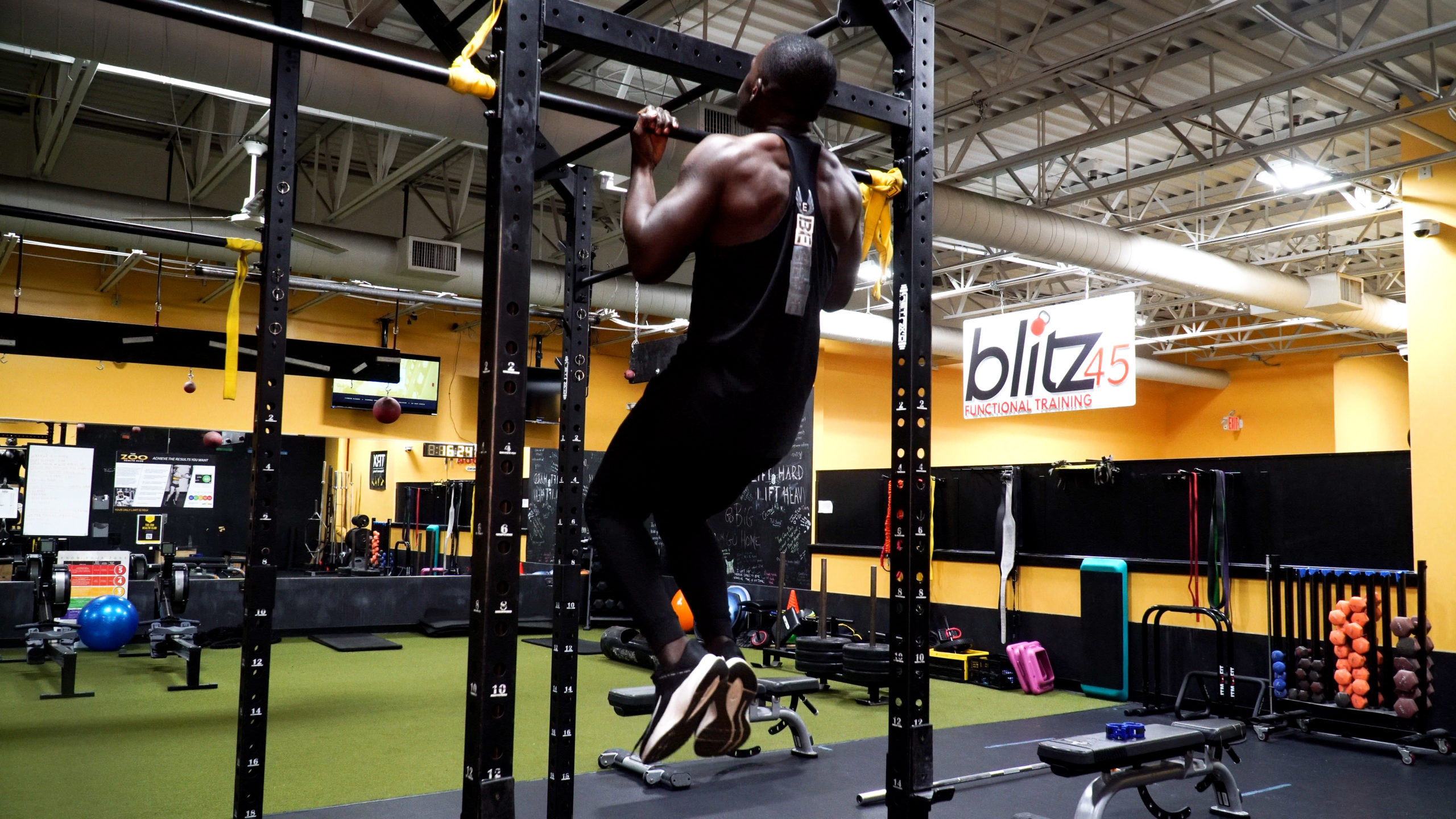 man completing chin ups for back workout