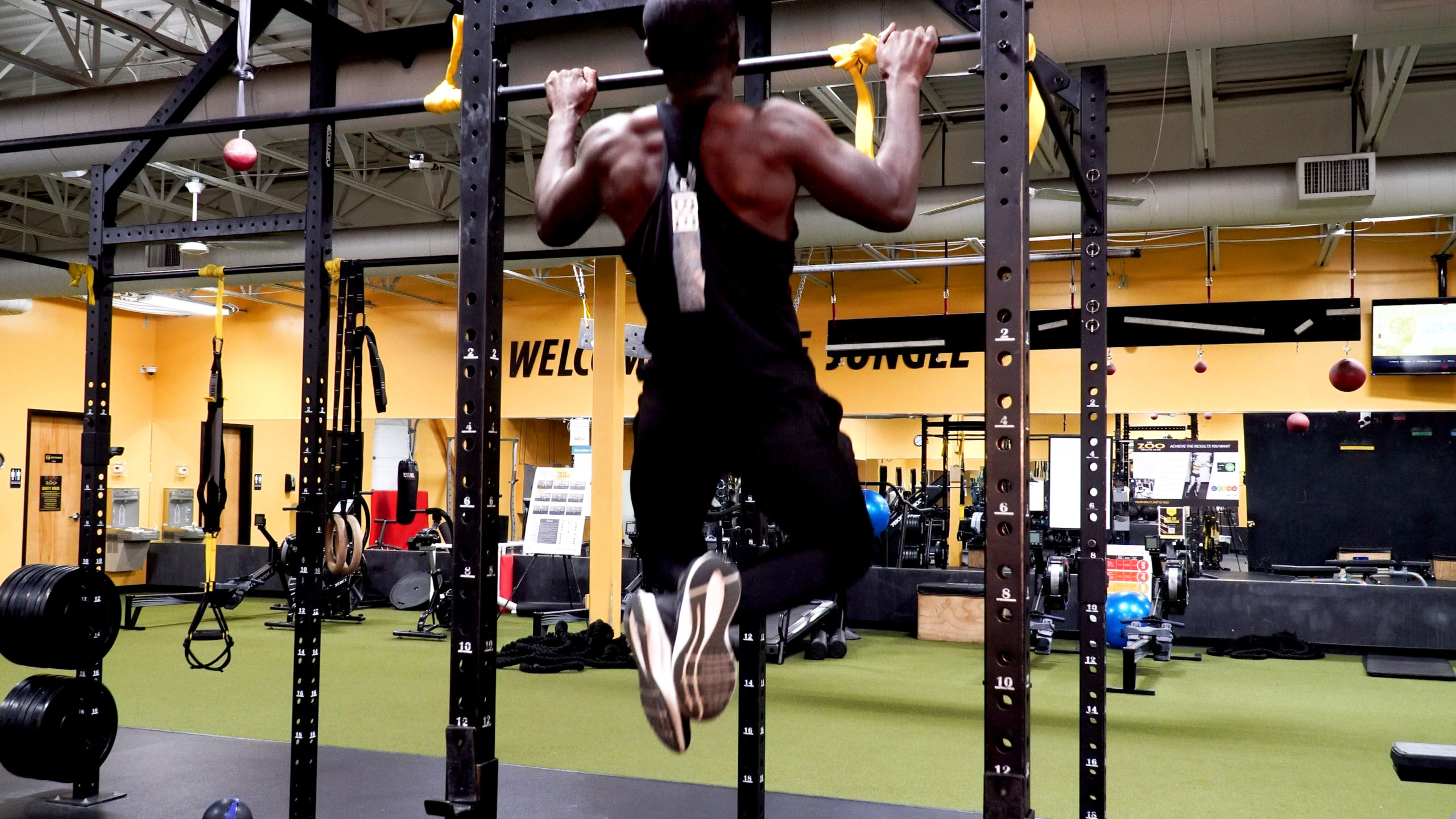 man completing pull up for back workout