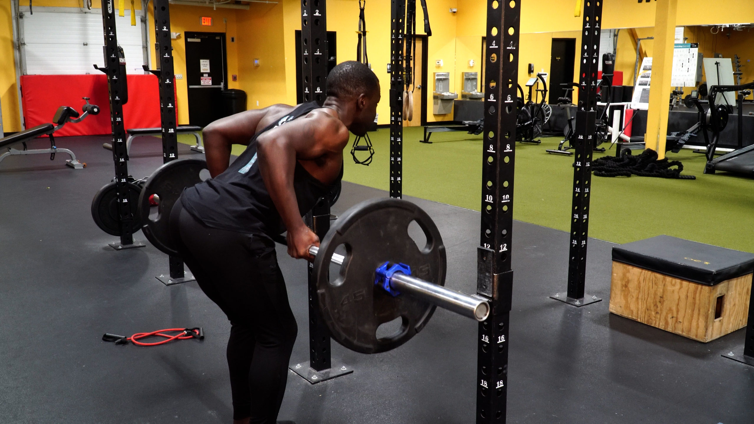 man completing underhand barbell row for back workout