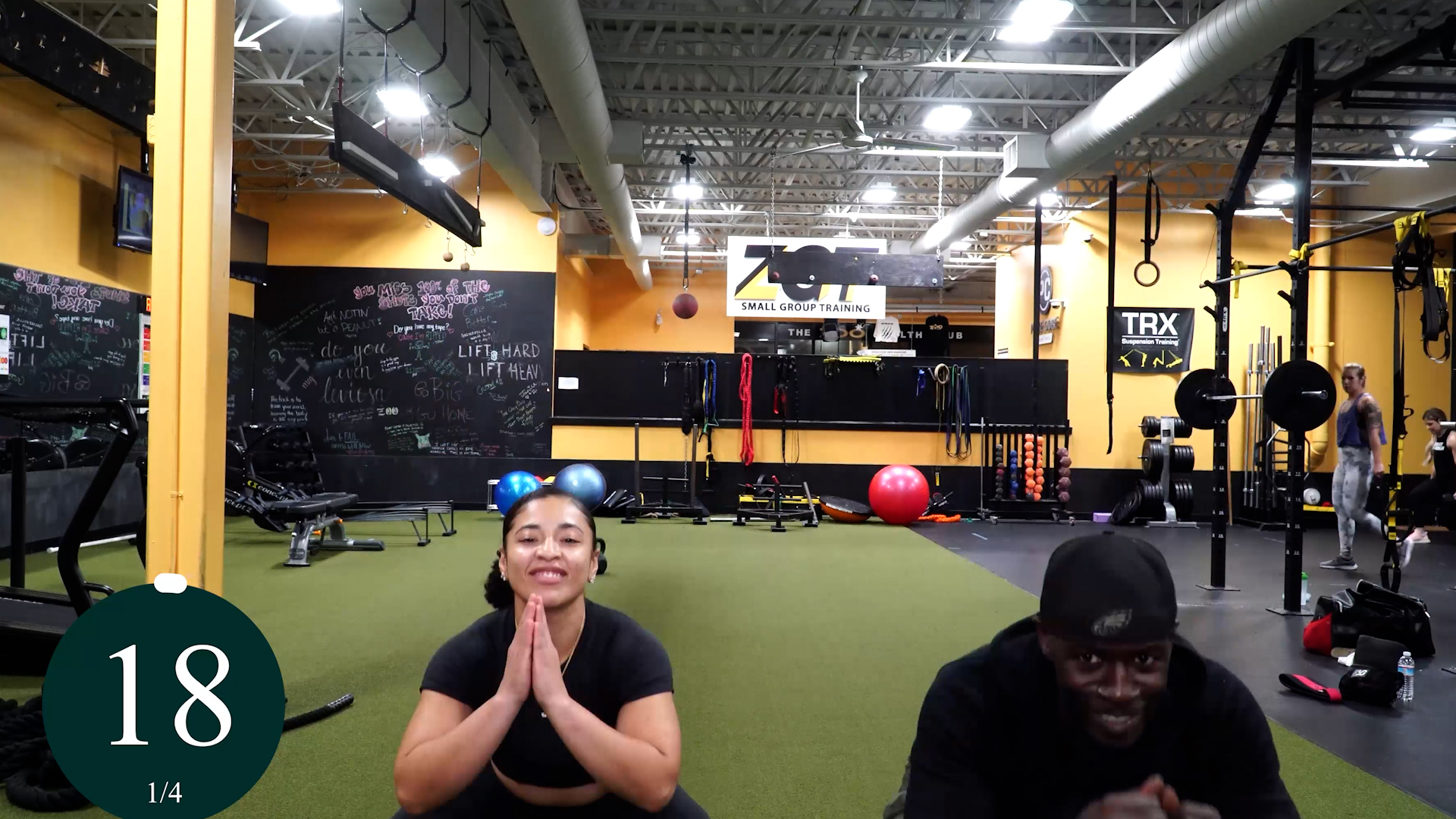 5 GLUTE EXERCISES SQUAT JUMPS 2 man and woman in squat position during at home glute workout