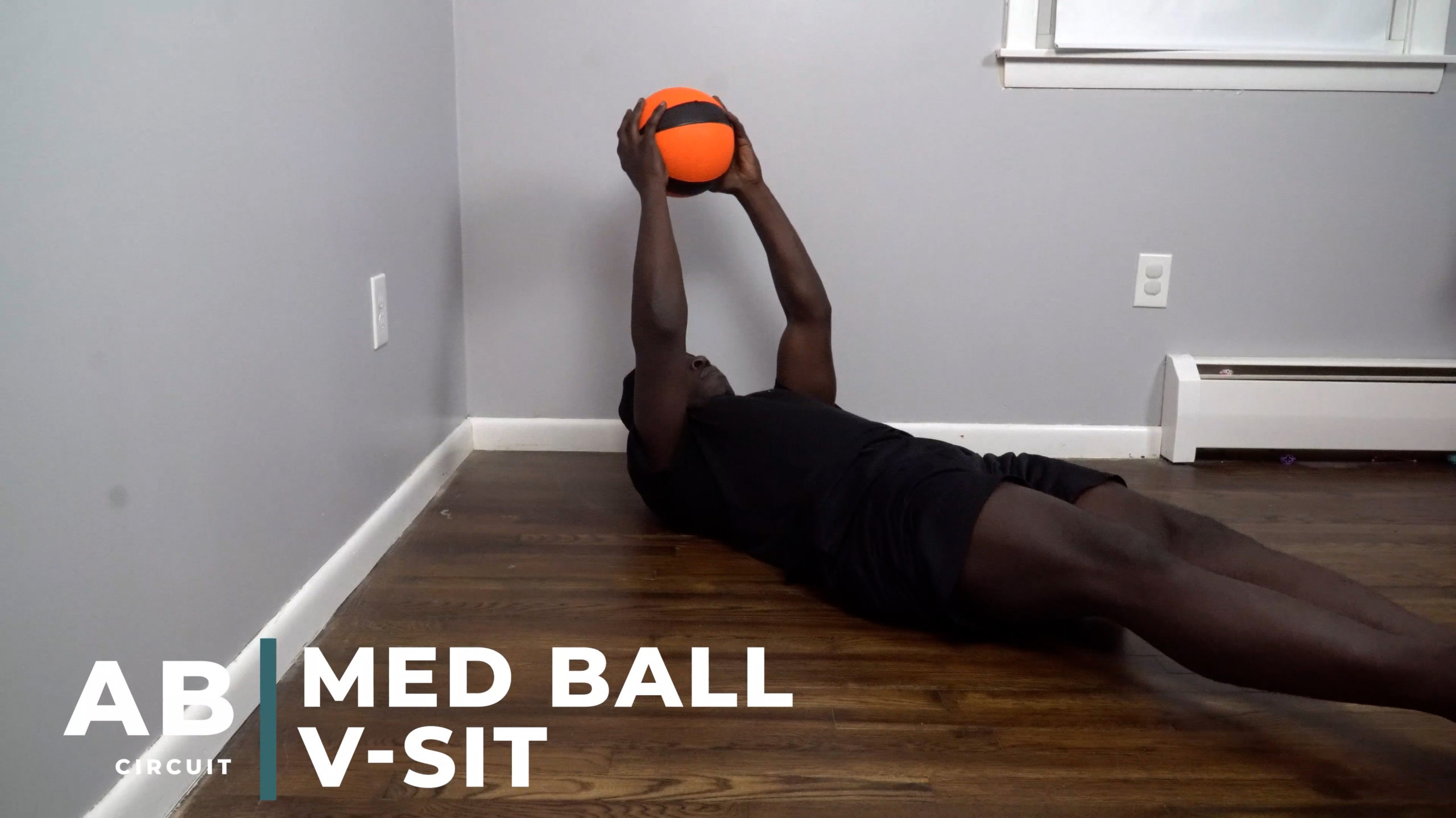 image of man doing abdominal v-sit with medicine ball start position