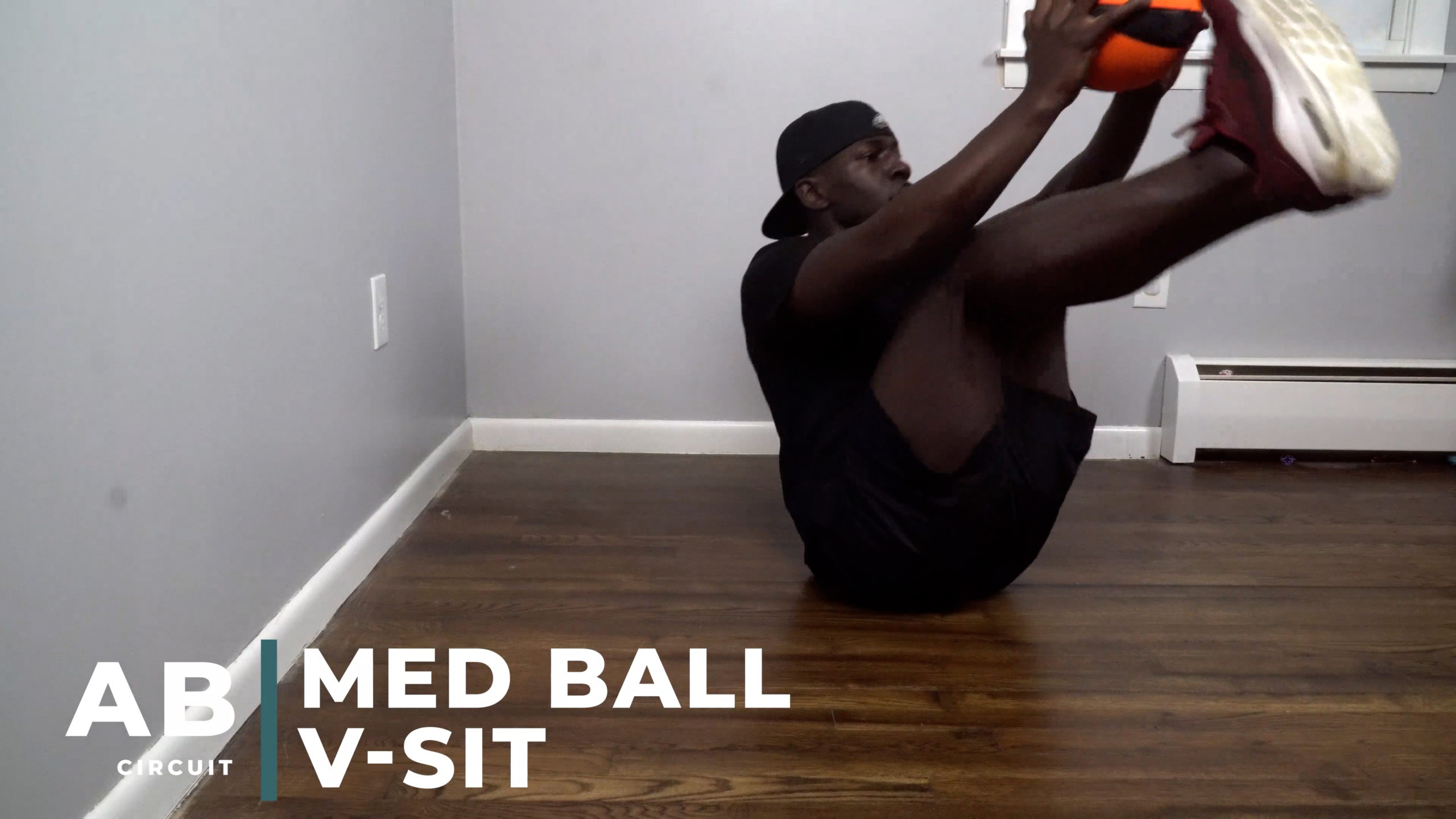 image of man doing abdominal v-sit with medicine ball finish position