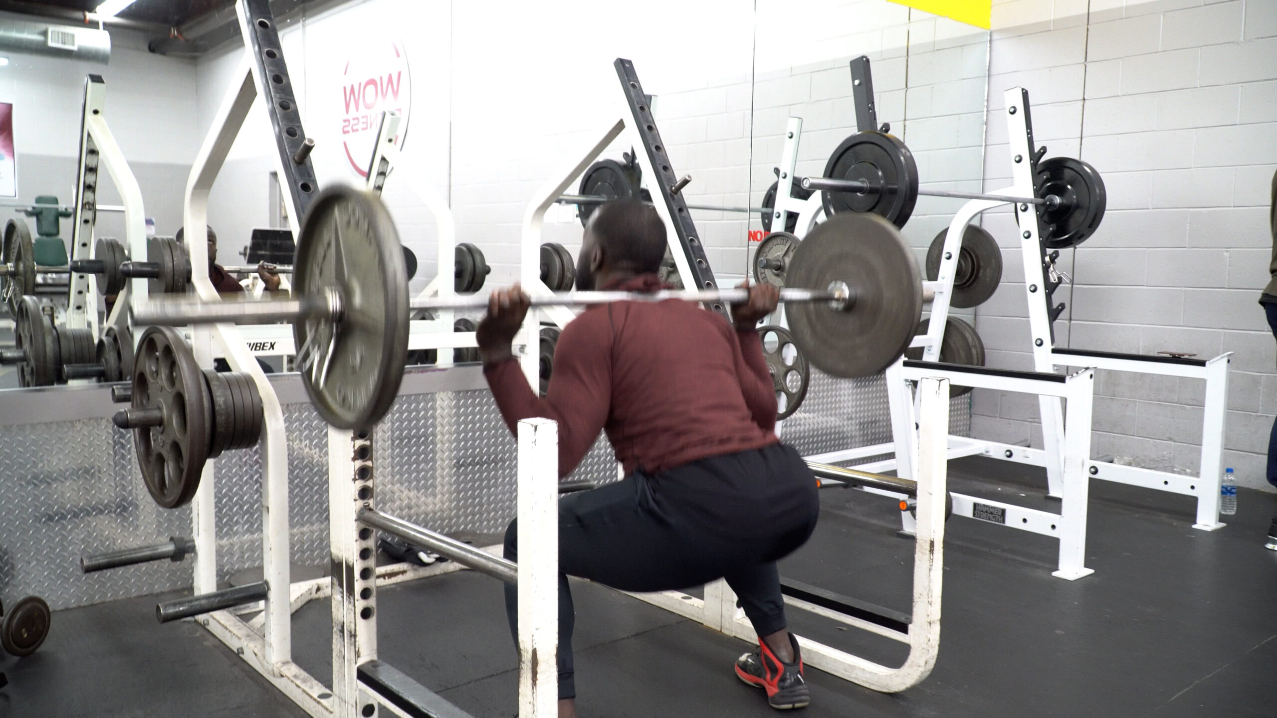 leg workout man doing barbell back squat