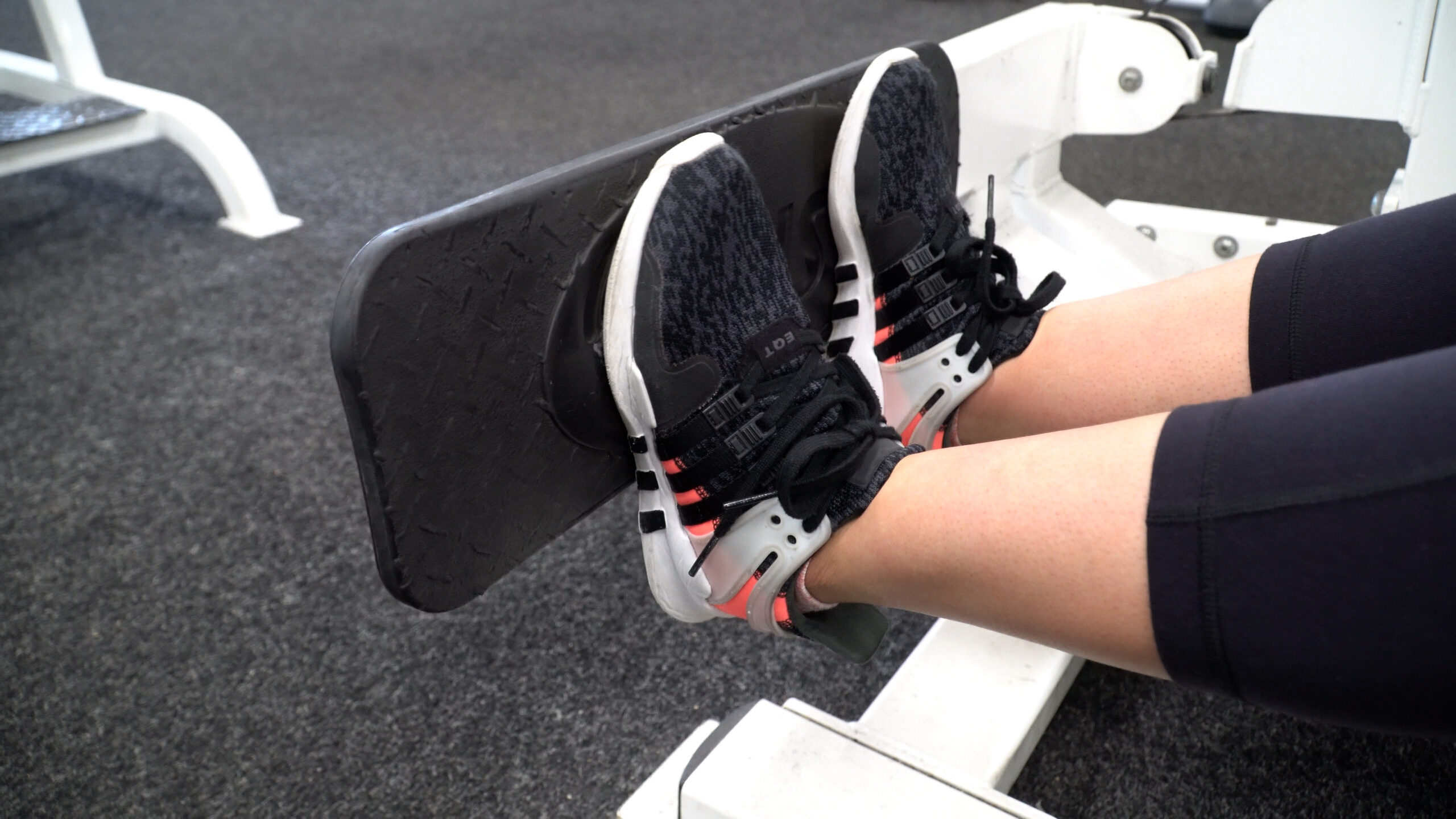 leg workout woman doing seated calf press
